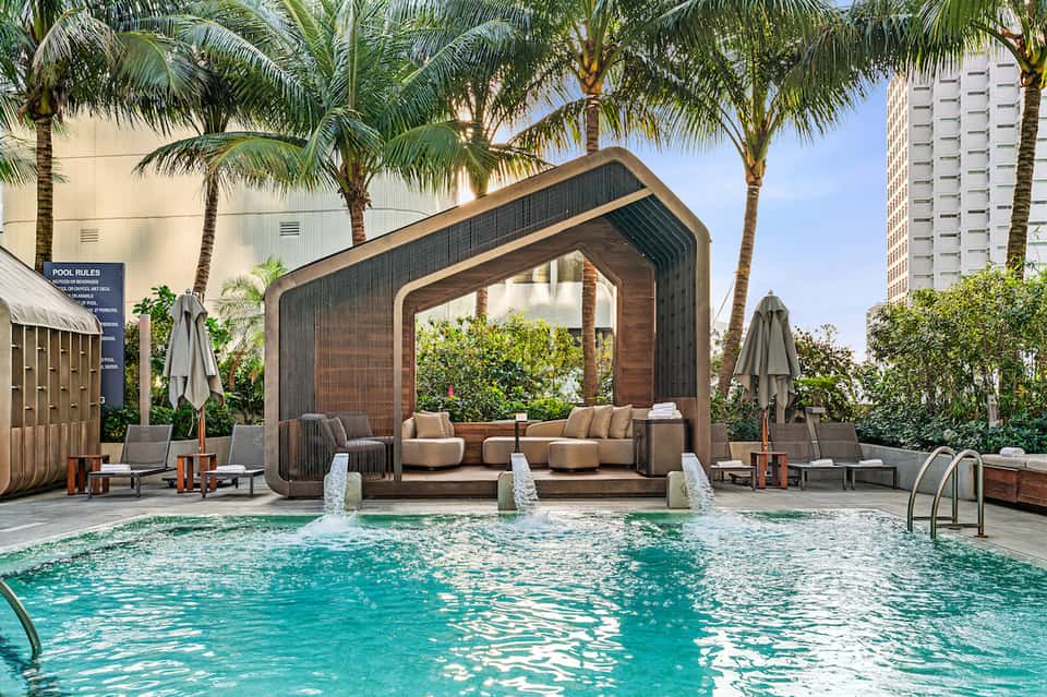 Resort pool with modern wooden pavilion and lounge seating area