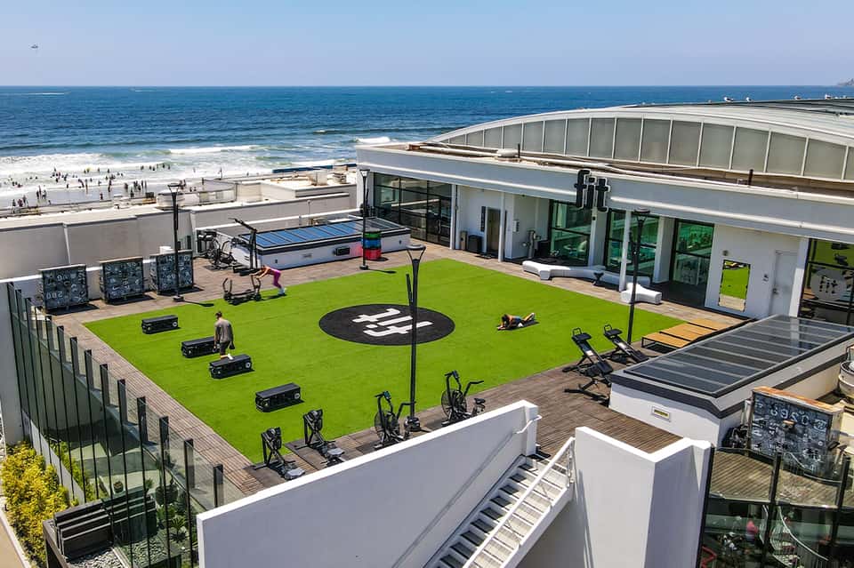 Beachfront resort rooftop with fitness area, pool, and ocean horizon