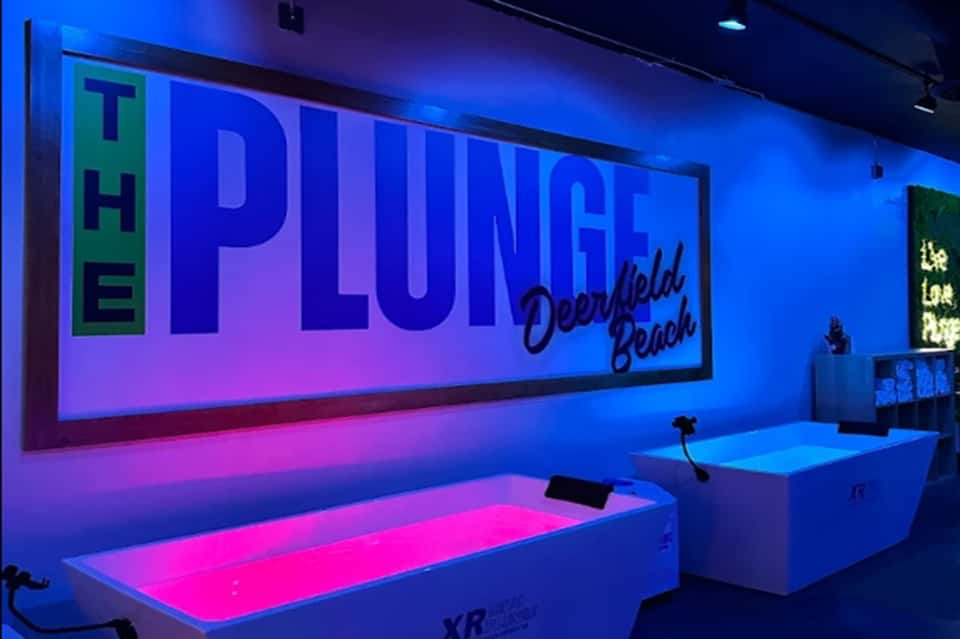 Neon glowing plunge pool display at The Plunge Deerfield Beach spa facility