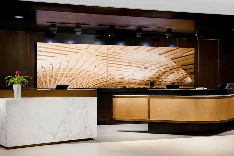 Sleek hotel reception desk with marble accents and wooden design elements