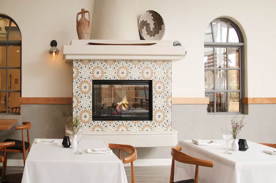 Elegant dining room with fireplace and patterned tile surround