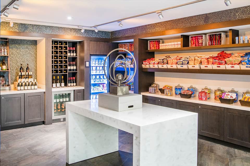 Modern resort gift shop interior with wine display, snacks, and merchandise shelving