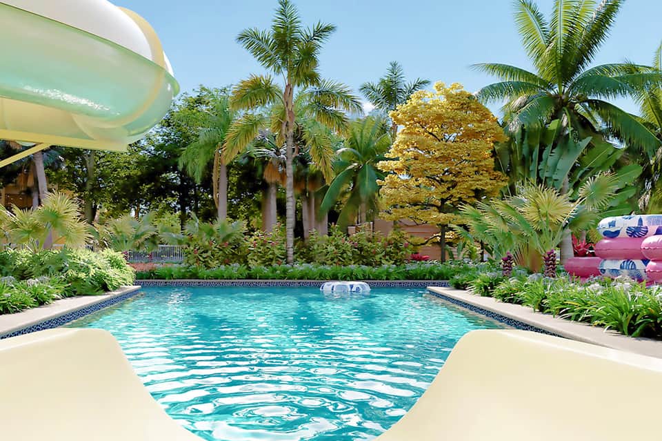 Luxurious resort pool surrounded by palm trees and tropical landscaping with lounge seating