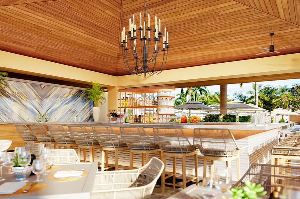 Open-air beachfront bar with wooden ceiling, chandelier, and ocean view