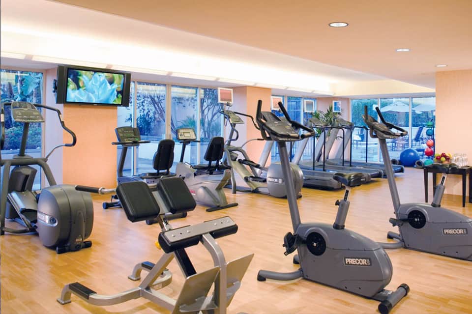 Fitness center with cardio equipment, exercise bikes, and panoramic windows