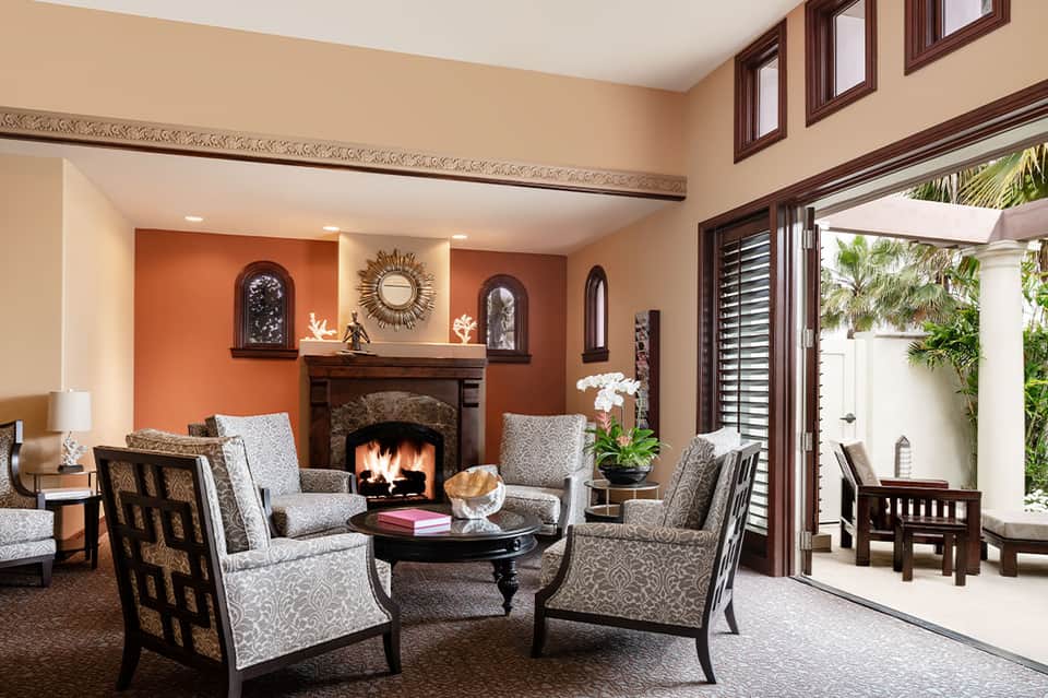 Elegant living room with orange accent walls, fireplace, and modern furnishings