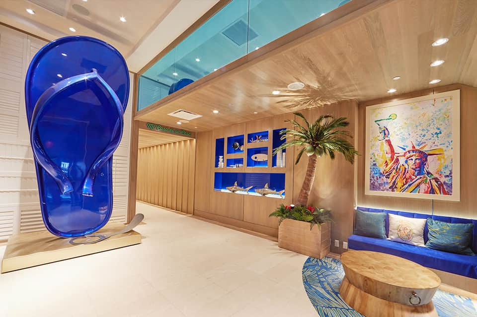 Luxury spa lounge with wooden ceiling, blue accent shelving, and modern seating