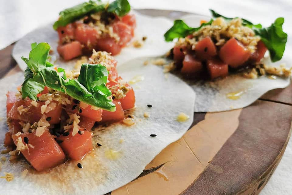Gourmet tuna tartare appetizers with microgreens on white plate