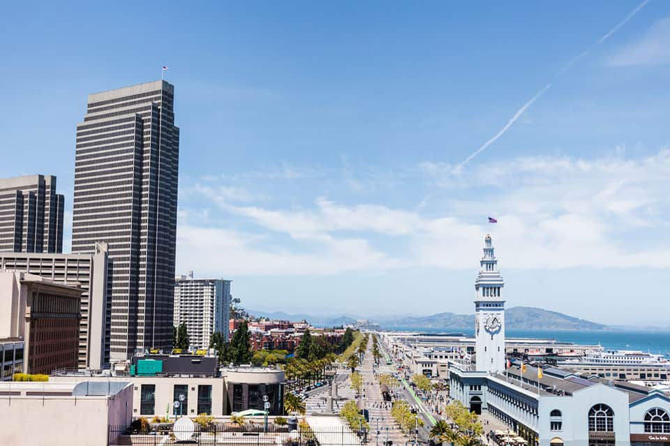 San Francisco cityscape featuring Ferry Building clock tower and bay waterfront view