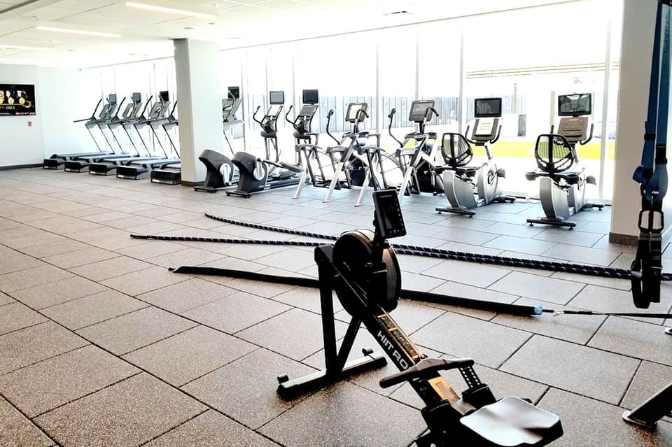 Modern fitness center with treadmills, stationary bikes, and exercise equipment