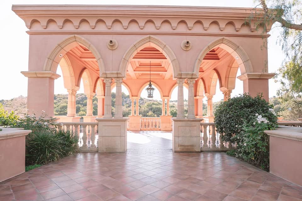 Pink Mediterranean-style pavilion with arched columns and ocean view