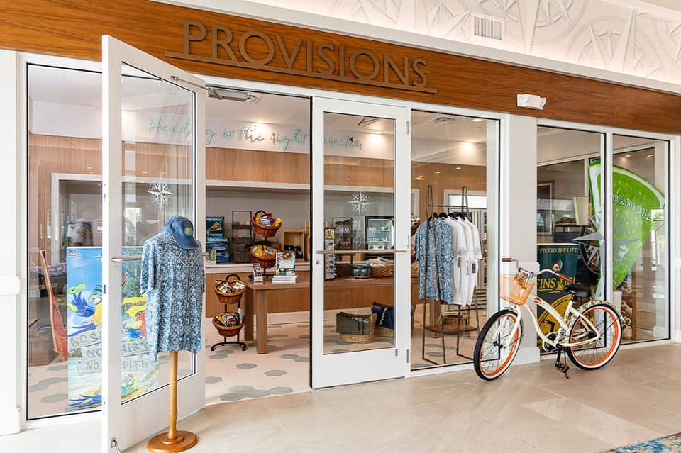 Provisions retail shop storefront with clothing displays and bicycle outside