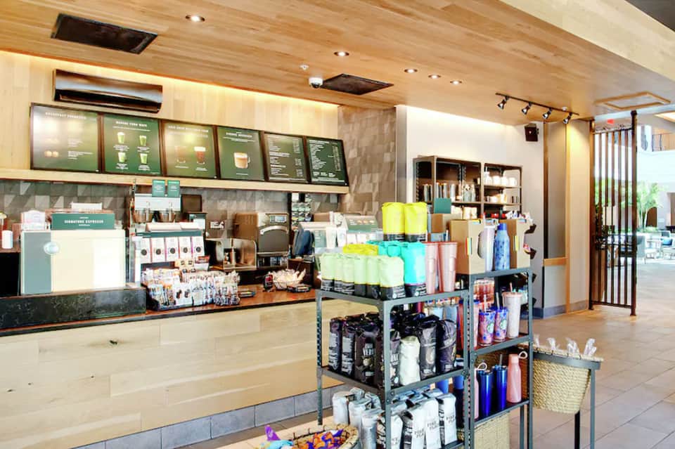 Coffee shop counter with wooden ceiling, menu boards, and retail merchandise display