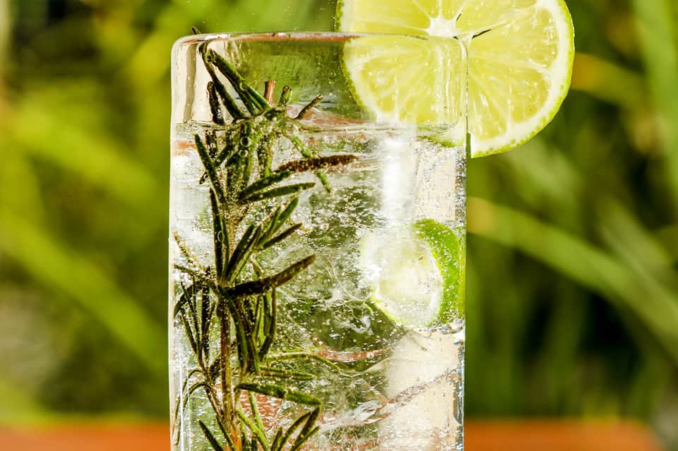 Refreshing mojito cocktail with fresh mint, lime slice, and ice in a clear glass