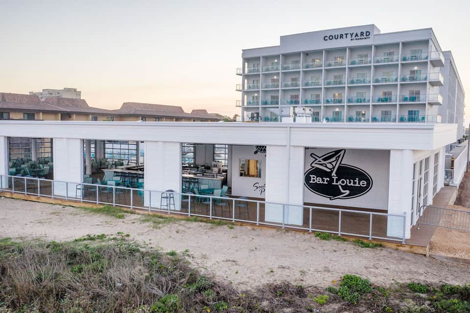 Beachfront bar and restaurant with Courtyard hotel building in background