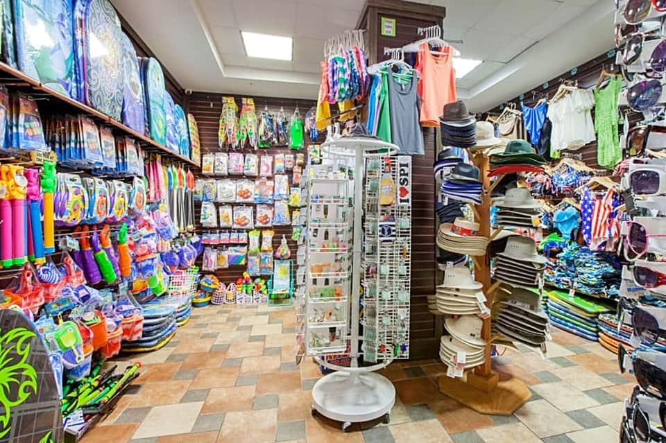 Colorful beach shop interior displaying swimwear, hats, towels and summer accessories