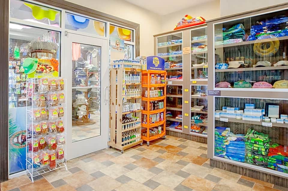 Resort gift shop interior with colorful merchandise, shelving, and display racks
