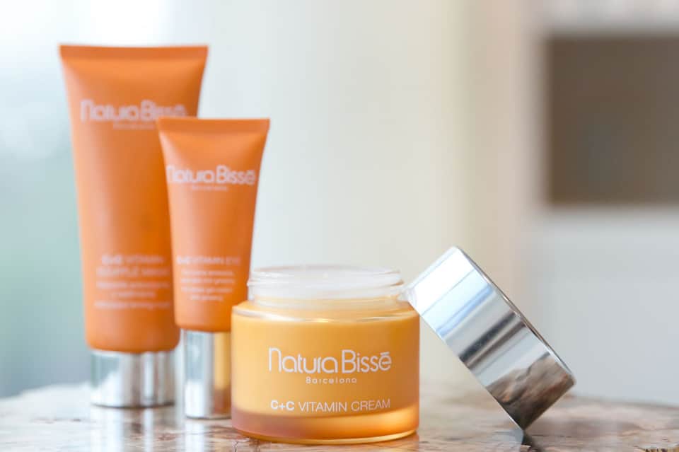 Natura Bissé skincare products including vitamin C cream and sunscreen tubes