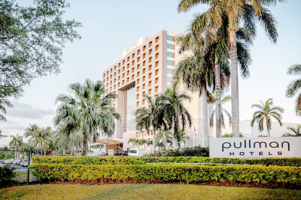 Pullman Hotels beachfront property with palm trees and manicured landscaping