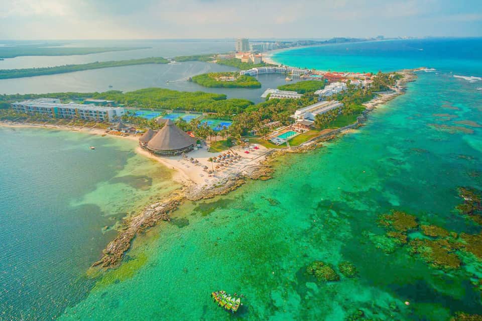 Aerial view of tropical all-inclusive resort on a peninsula with turquoise waters