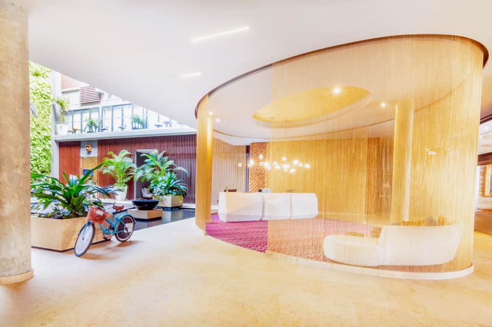 Contemporary spa reception area with golden curved walls and minimalist furniture