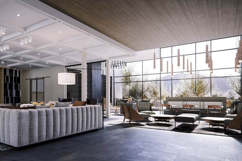 Modern lobby with curved gray sofa, floor-to-ceiling windows, and contemporary lighting fixtures