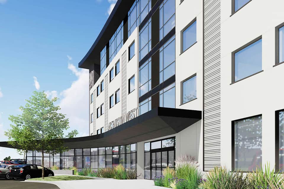 Contemporary hotel building exterior with glass windows and ground-level retail entrance