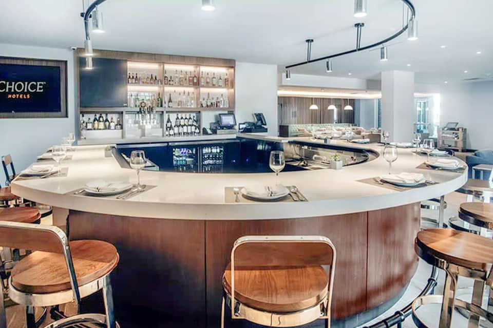 Modern hotel restaurant with curved bar counter and place settings