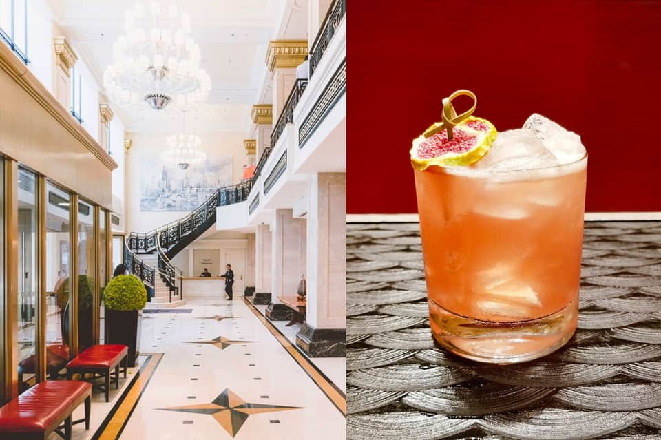 Luxury hotel lobby with spiral staircase and chandelier; craft cocktail with fruit garnish on dark surface