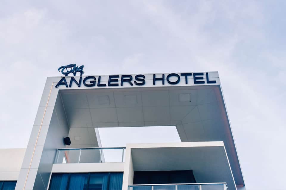 Anglers Hotel exterior signage on modern white building facade