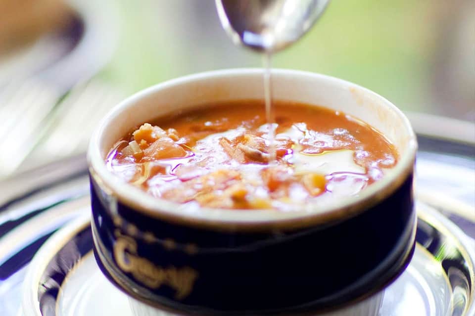 Luxury spa treatment with aromatic oil being drizzled into a bowl