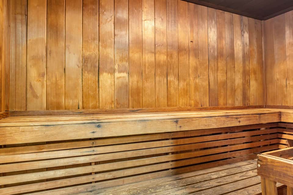 Wooden sauna interior with bench seating and paneled walls