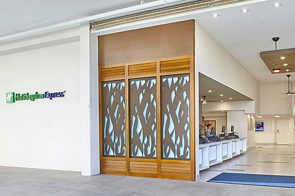 Holiday Inn Express hotel lobby entrance with decorative wooden doors and reception desk
