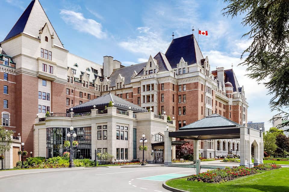 Grand Victorian castle-style hotel with brick facade, turrets, and manicured grounds