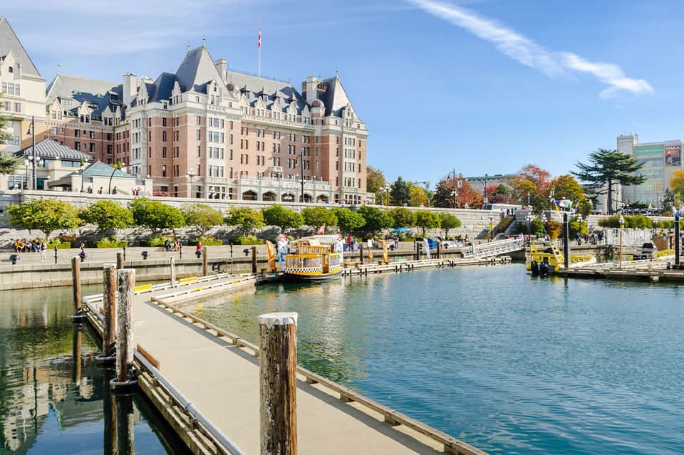 Historic brick castle hotel with harbor and yellow water taxi boats in foreground