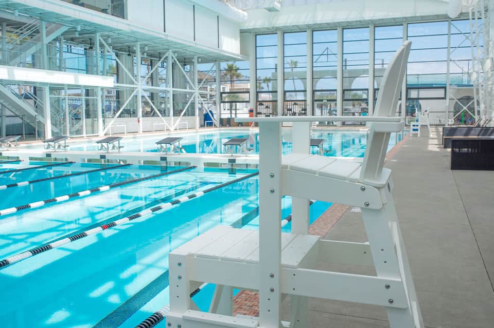Indoor competition swimming pool with lap lanes and large windows