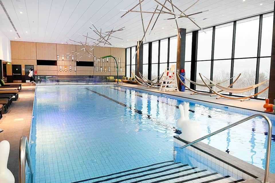 Indoor swimming pool with lane markings and large windows