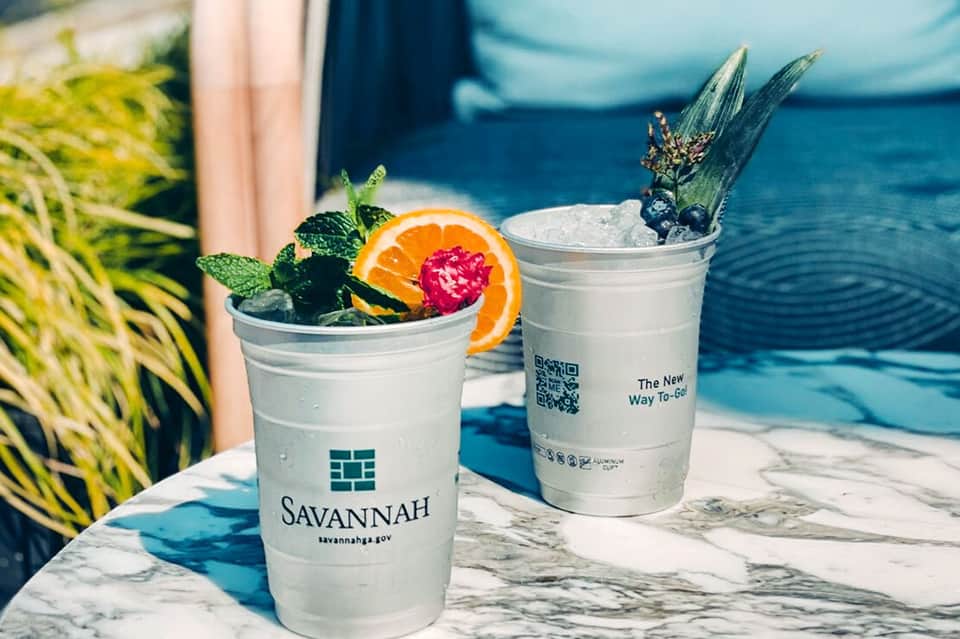 Colorful tropical cocktails with orange slices and mint at poolside bar