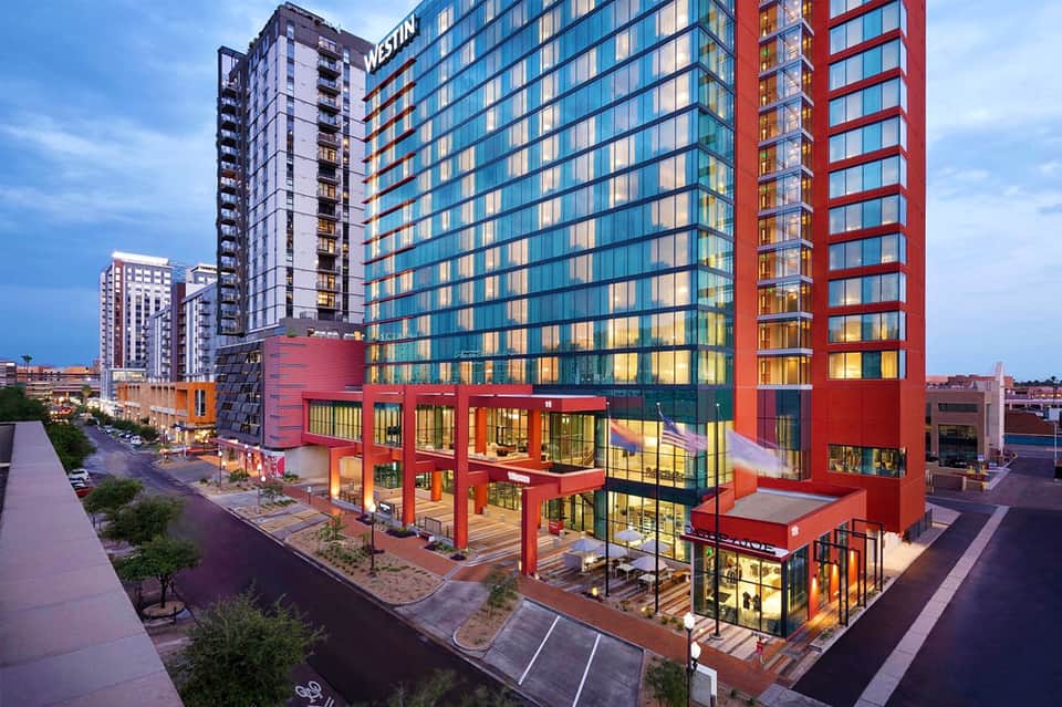 Modern Westin hotel exterior with colorful red and blue facade at dusk
