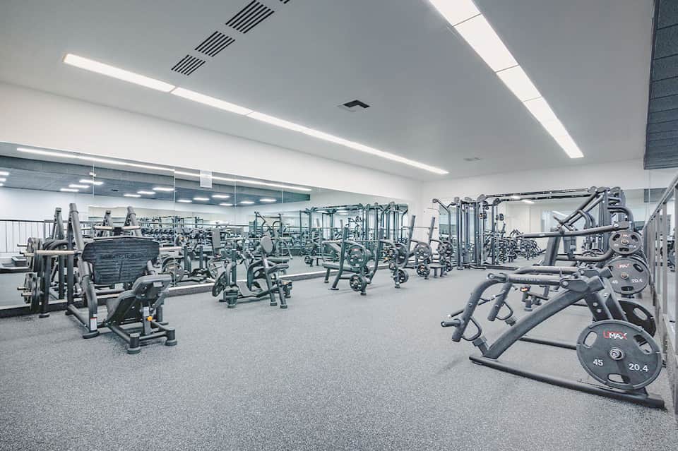 State-of-the-art fitness center with exercise equipment and mirrored walls