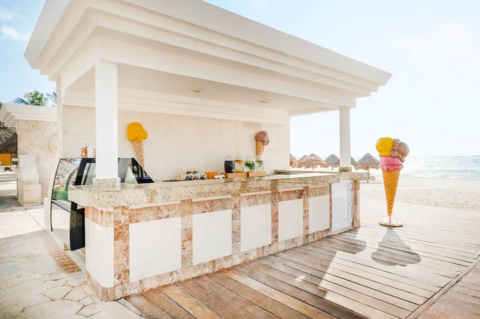 Beachfront ice cream stand with white modern architecture and ocean view