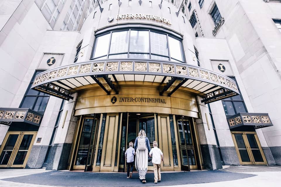 Classic Inter-Continental hotel entrance with ornate awning, white marble facade, and brass doors
