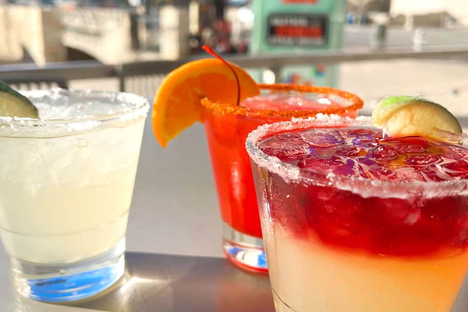 Colorful cocktails with citrus garnish and salted rims served poolside
