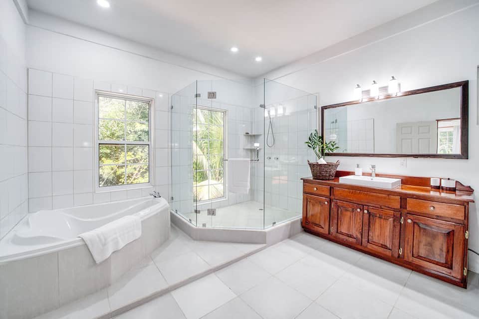Luxury master bathroom with soaking tub, walk-in shower, and wooden vanity