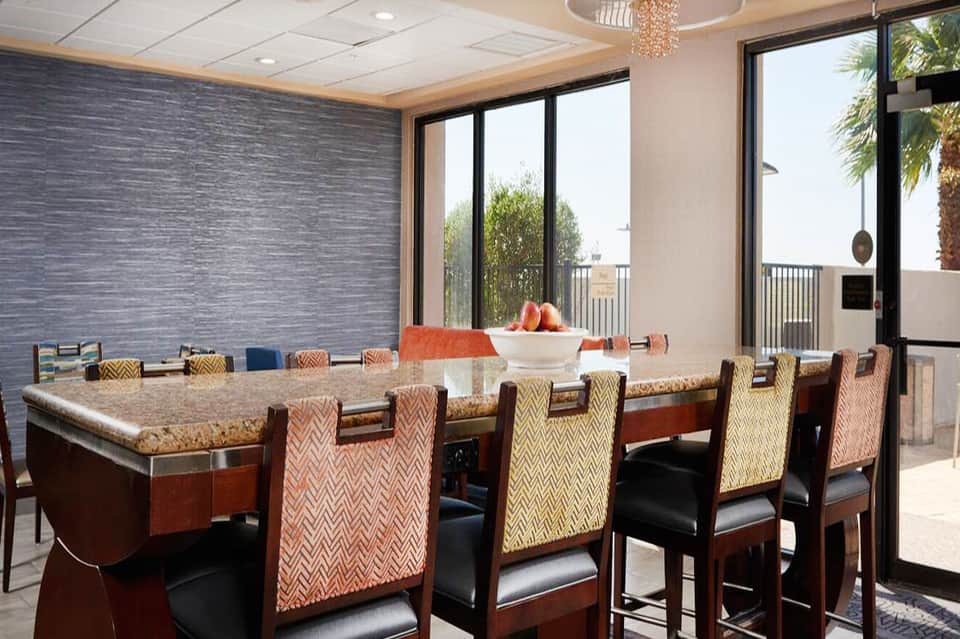 Modern conference room with geometric patterned chairs, granite countertop, and ocean view terrace