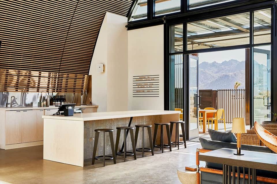 Modern kitchen and lounge area with mountain views, bar seating, and contemporary design