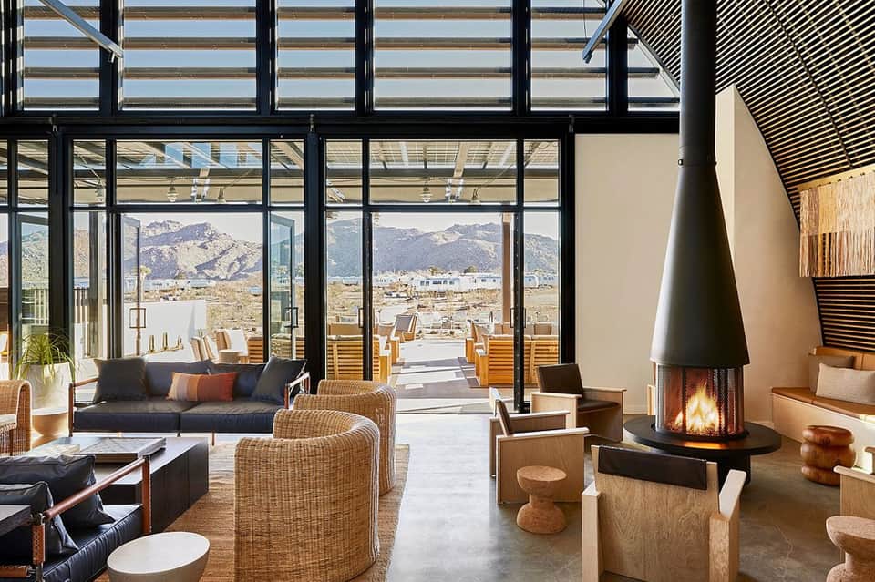 Luxury lounge with fireplace, mountain views through floor-to-ceiling windows