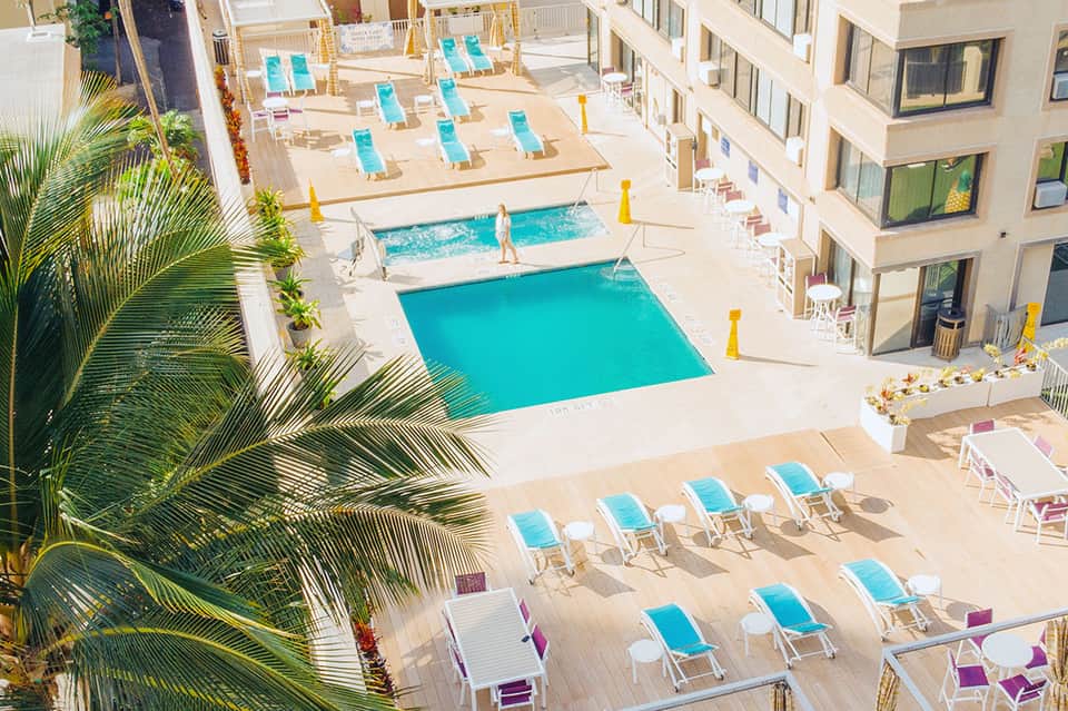 Aerial view of resort pool complex with turquoise pools and sun loungers