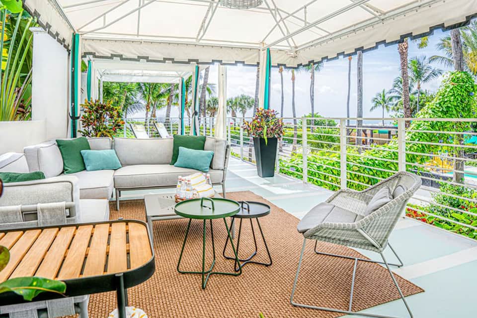 Modern covered terrace with coastal views, lounge seating, and turquoise accents