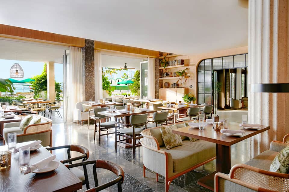 Modern beachfront restaurant with open-concept dining, ocean views, and natural wood accents
